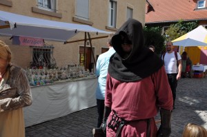 Characters dressed in medieval garb: this one, carrying an executioner's ax